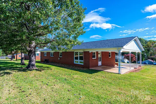 a view of a house with a yard porch and sitting area