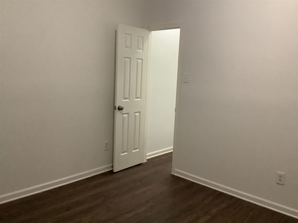1601 Oak Pl Court Pearland, TX 77581 - Photo 14 of 21 an empty room with wooden floor