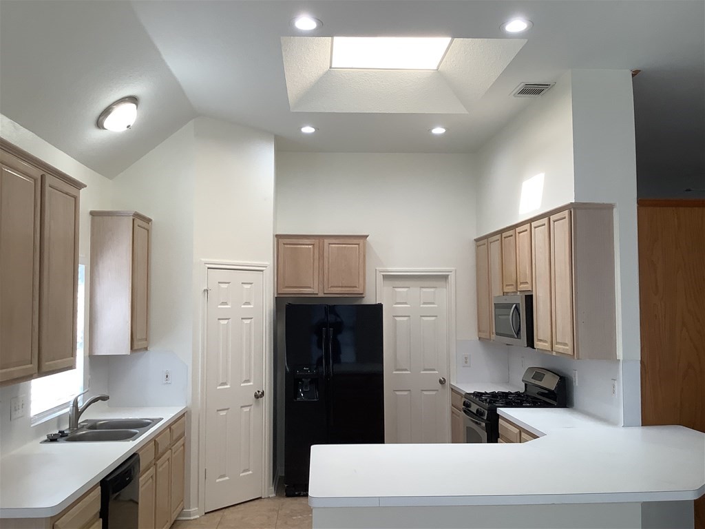 1601 Oak Pl Court Pearland, TX 77581 - Photo 3 of 21 a kitchen with stainless steel appliances a refrigerator sink and stove