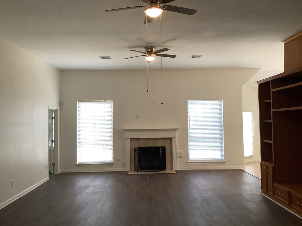 1601 Oak Pl Court Pearland, TX 77581 - Photo 5 of 21 an empty room with windows fireplace and a sink