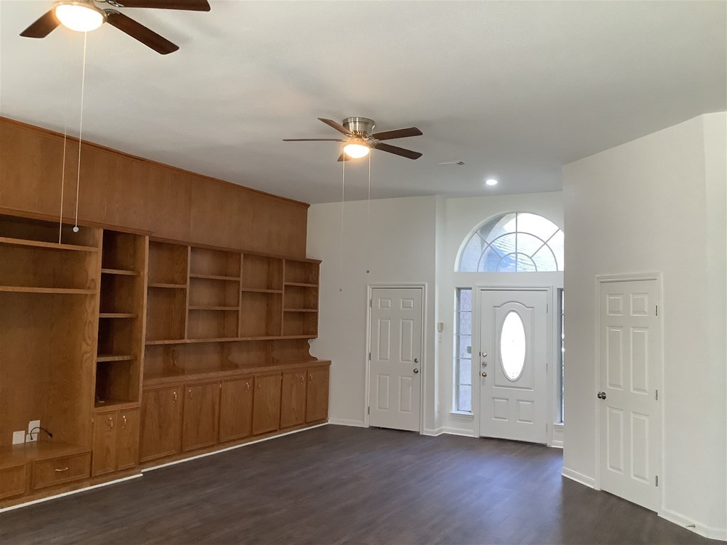 1601 Oak Pl Court Pearland, TX 77581 - Photo 6 of 21 wooden floor in an empty room with a window