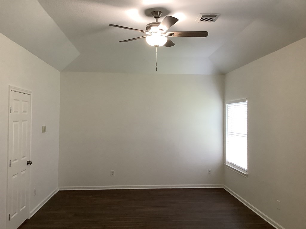 1601 Oak Pl Court Pearland, TX 77581 - Photo 9 of 21 wooden floor in an empty room with a window