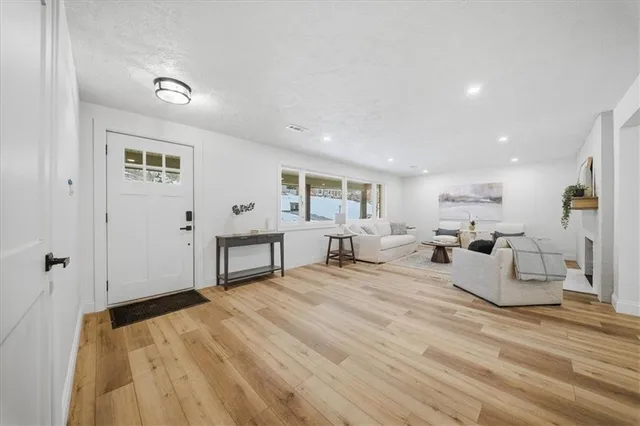 a living room with furniture and a wooden floor