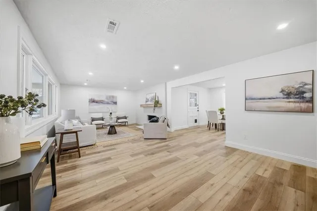 a living room with furniture and wooden floor
