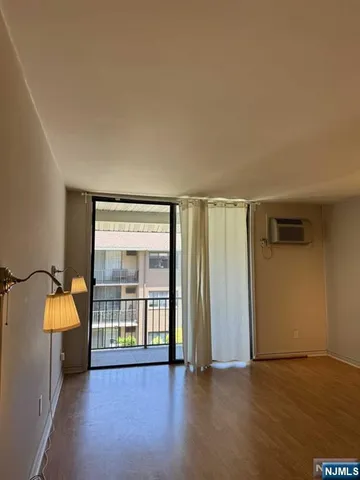 an empty room with wooden floor and a window