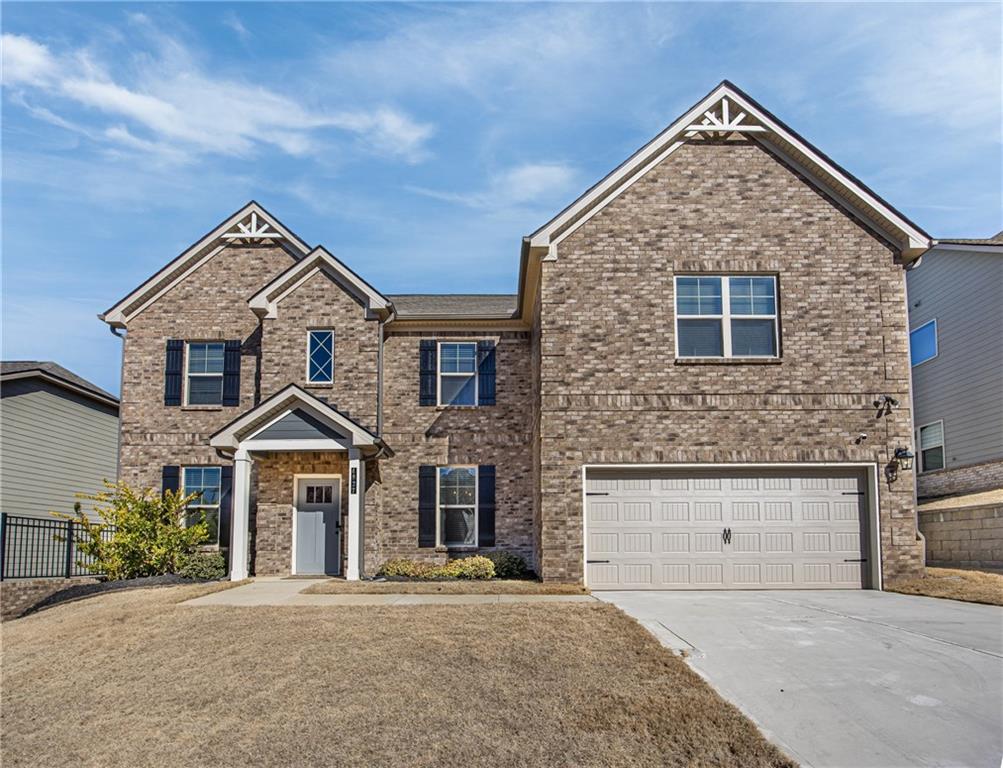 4827 Sultana Way Atlanta, GA 30331 - Photo 1 of 24 a front view of a house with a yard and garage