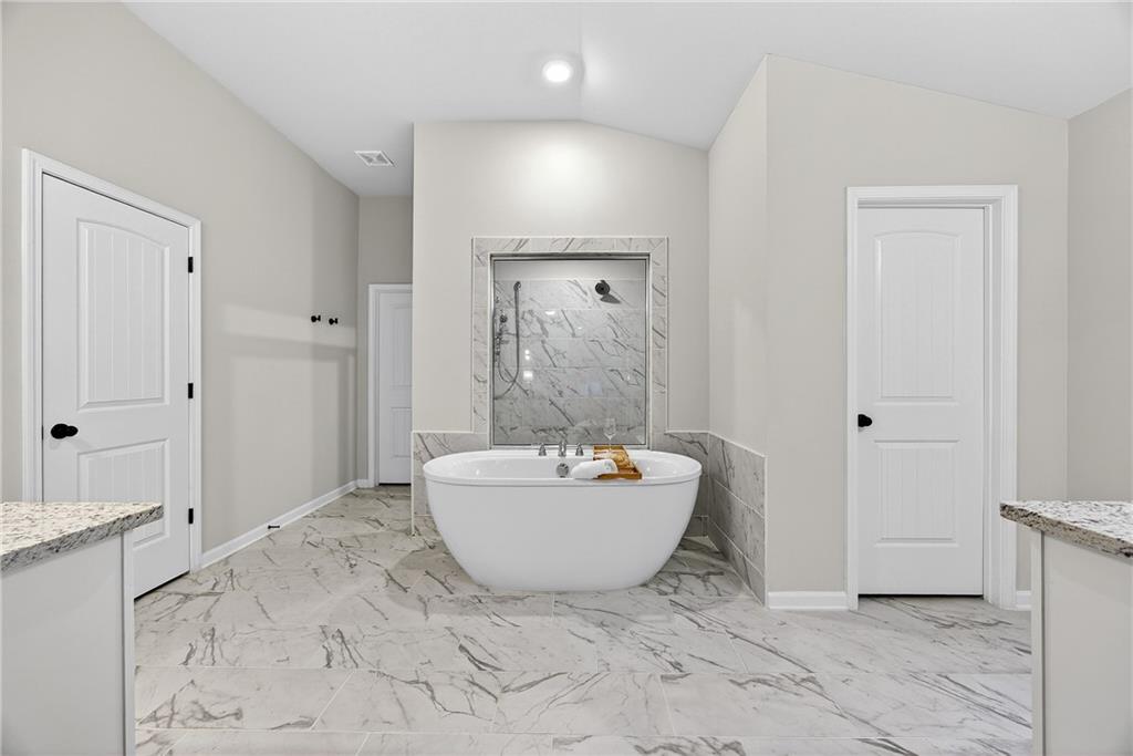 4827 Sultana Way Atlanta, GA 30331 - Photo 12 of 24 a spacious bathroom with a bathtub sink and mirror