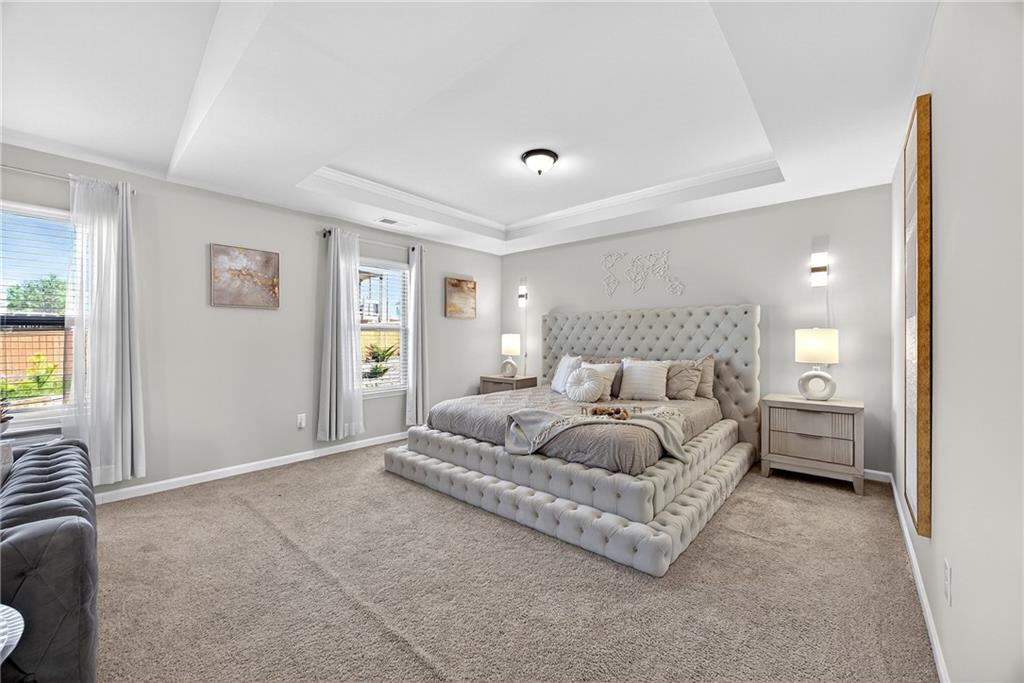 4827 Sultana Way Atlanta, GA 30331 - Photo 14 of 24 a spacious bedroom with a bed and a couch
