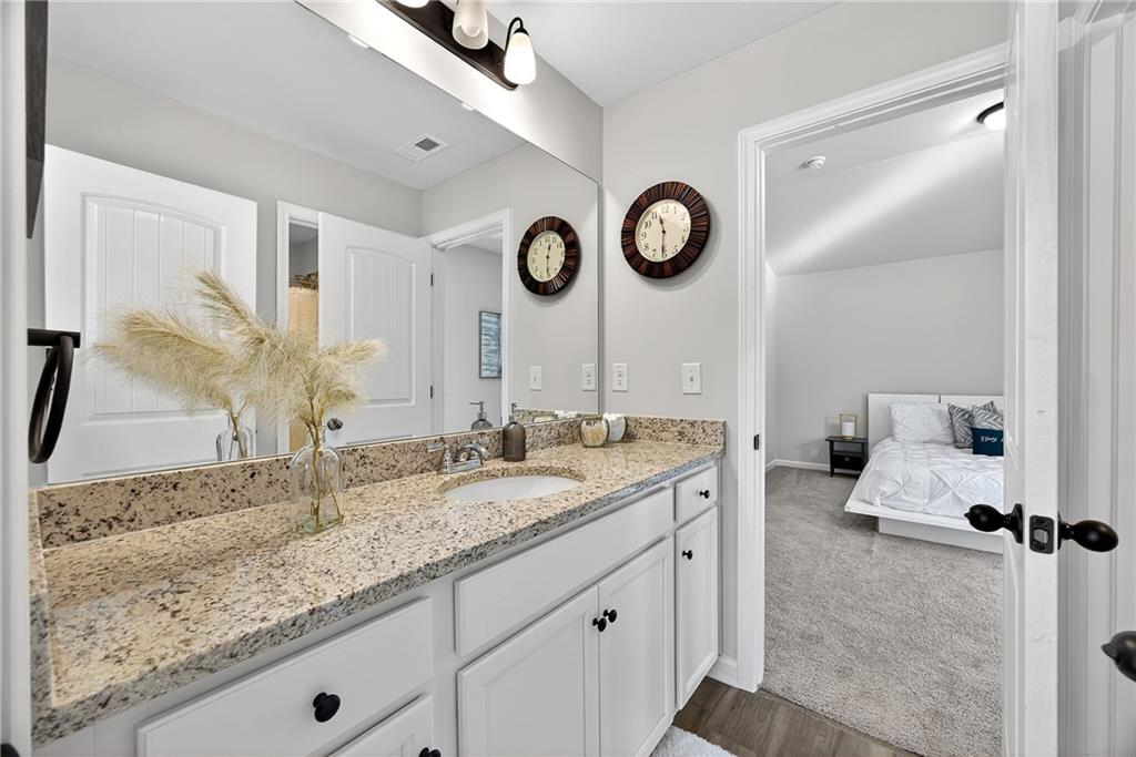 4827 Sultana Way Atlanta, GA 30331 - Photo 16 of 24 a bathroom with a granite countertop sink and a mirror