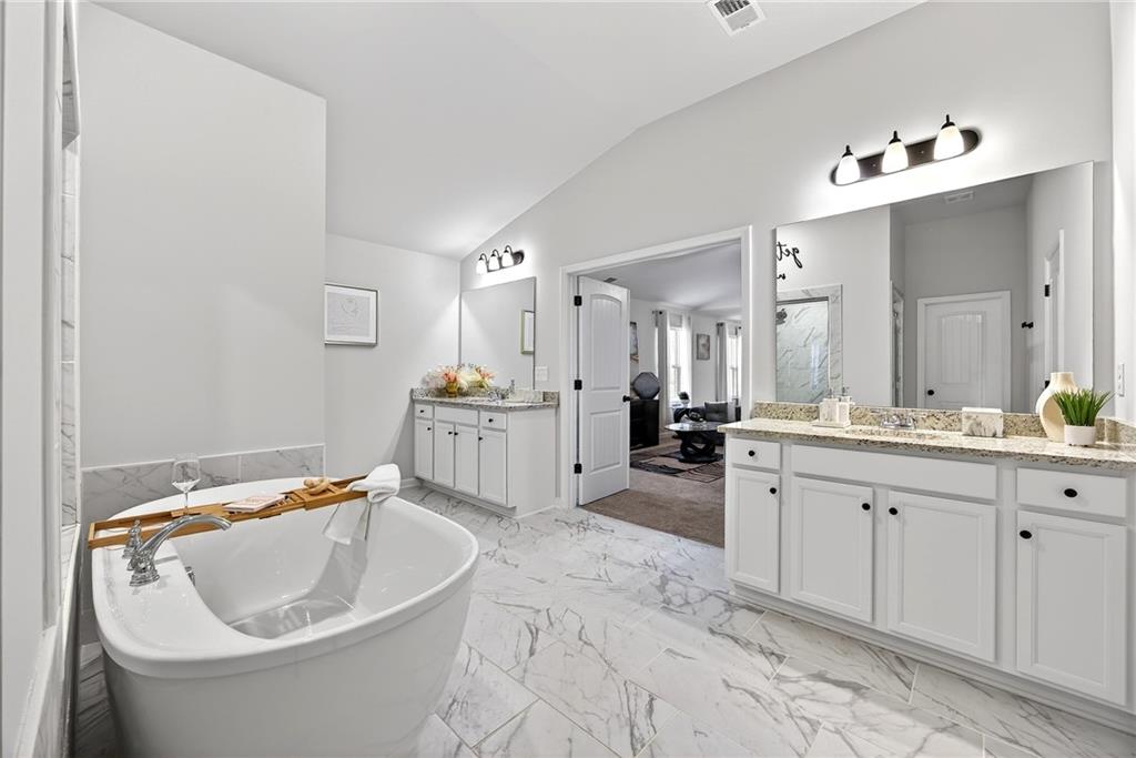 4827 Sultana Way Atlanta, GA 30331 - Photo 17 of 24 a bathroom with a bathtub sink and mirror