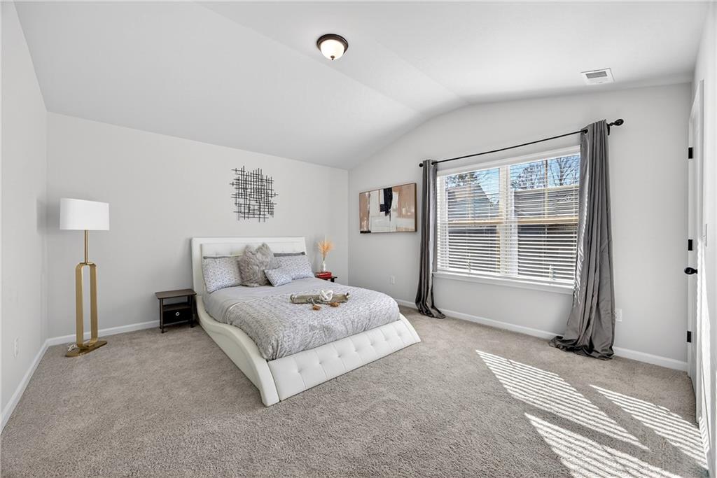 4827 Sultana Way Atlanta, GA 30331 - Photo 19 of 24 a spacious bedroom with a bed and a window
