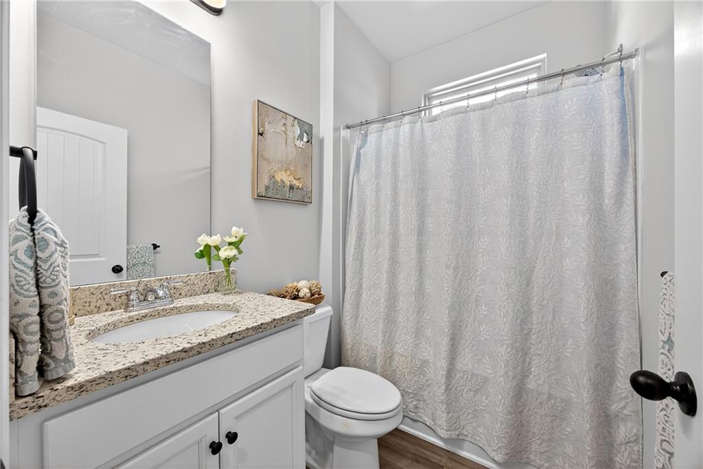 4827 Sultana Way Atlanta, GA 30331 - Photo 10 of 24 a bathroom with a granite countertop sink and a mirror