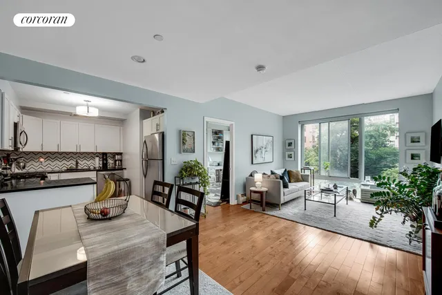 a living room with furniture stove and large window