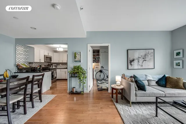 a living room with furniture kitchen and a table