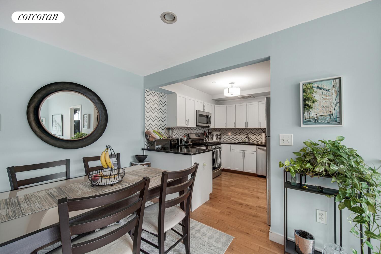 29 West 138th Street, Unit 4H Manhattan, NY 10037 - Photo 5 of 15 a living room with furniture a mirror and a table