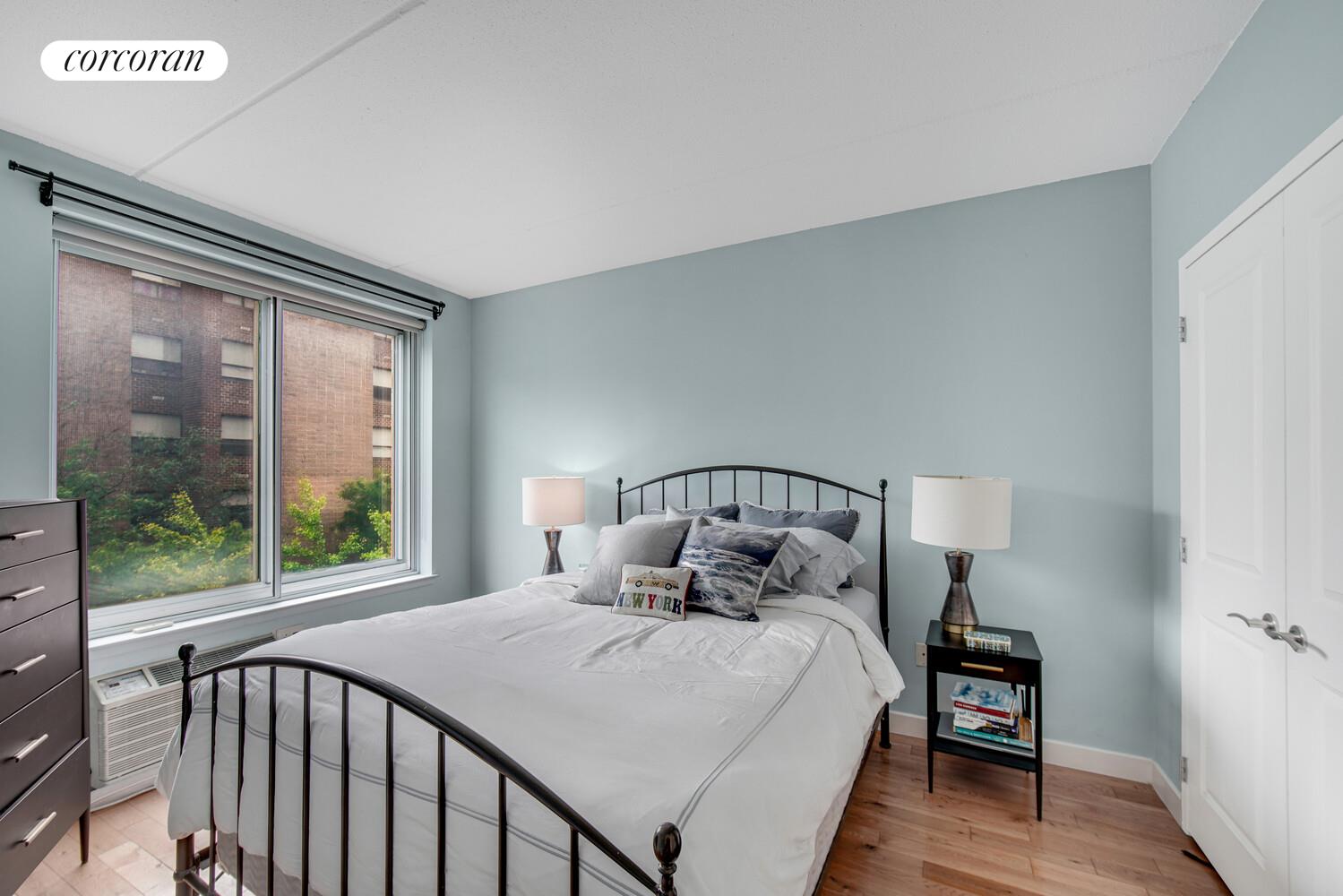 29 West 138th Street, Unit 4H Manhattan, NY 10037 - Photo 7 of 15 a bed sitting in a bedroom next to a window