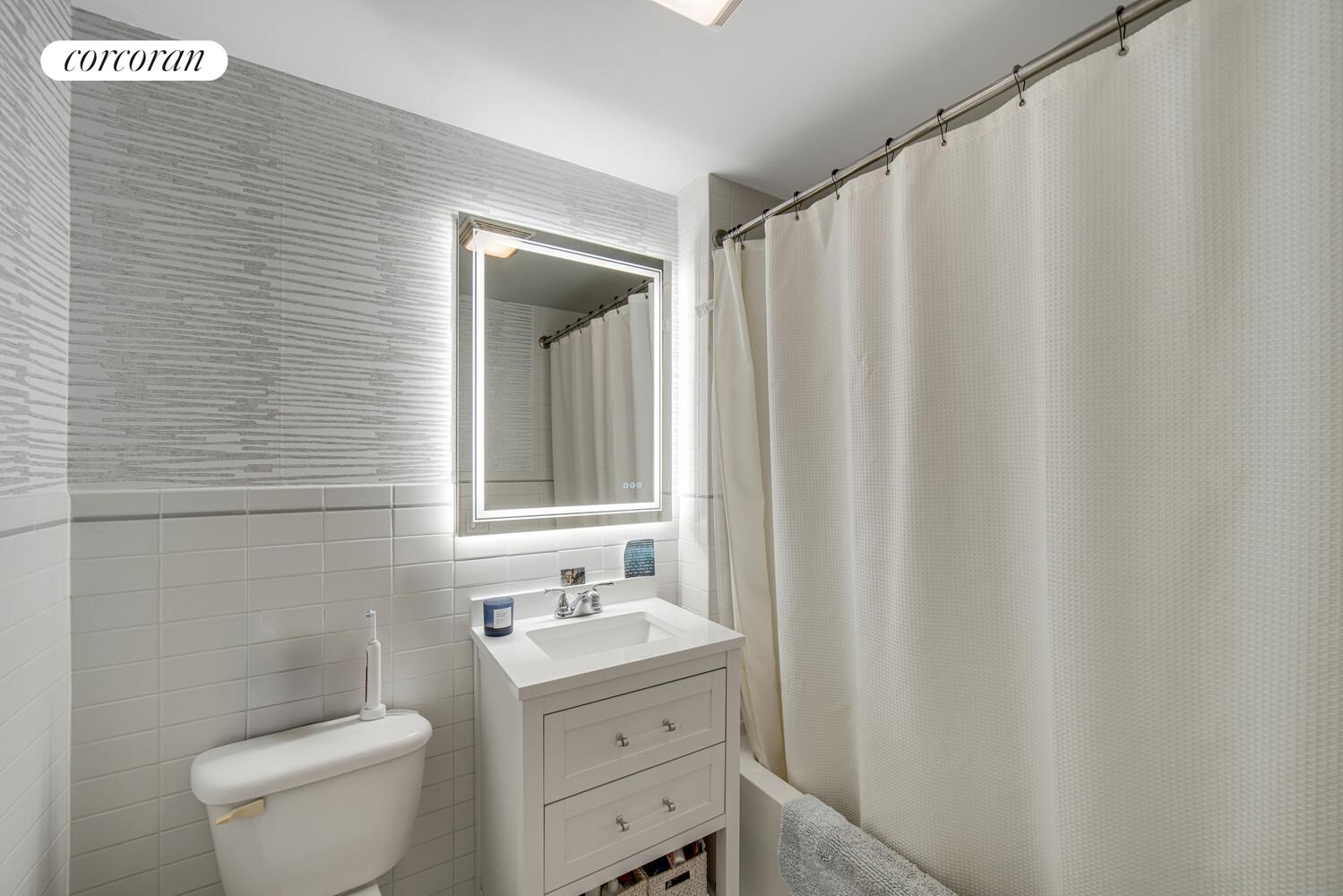 29 West 138th Street, Unit 4H Manhattan, NY 10037 - Photo 8 of 15 a bathroom with a toilet a sink and curtain