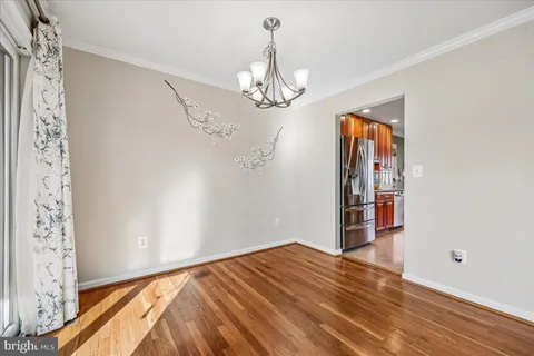 a view of a room that has a painting on the wall