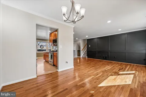a view of a hallway with wooden floor and stairs