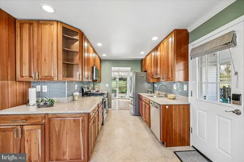 a view of a room with wooden floor and a ceiling fan