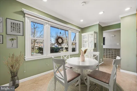 an empty room with wooden floor and ceiling fan