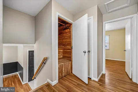a view of empty room with wooden floor and fireplace