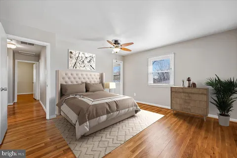 a view of an empty room with wooden floor fireplace and a window