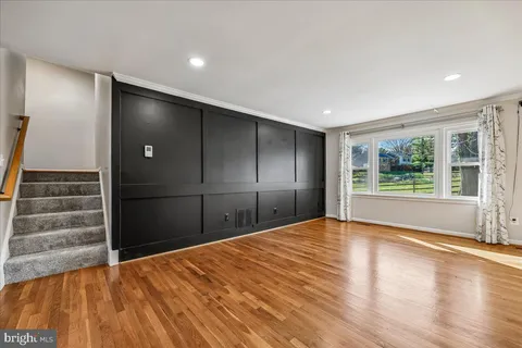 a view of a dining room with furniture a chandelier and wooden floor