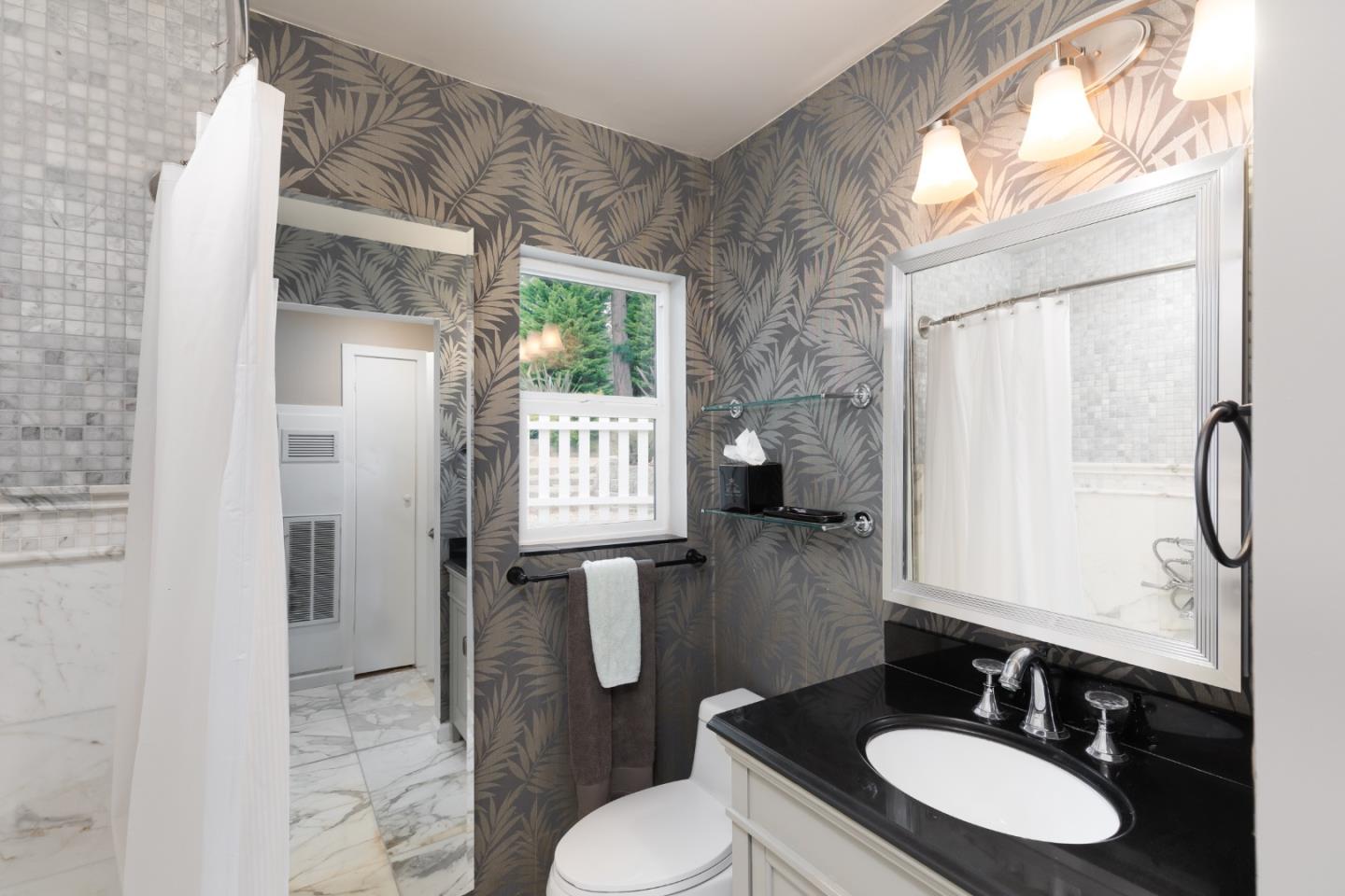 4106 Crest Road Pebble Beach, CA 93953 - Photo 23 of 43 a bathroom with a granite countertop sink toilet and shower