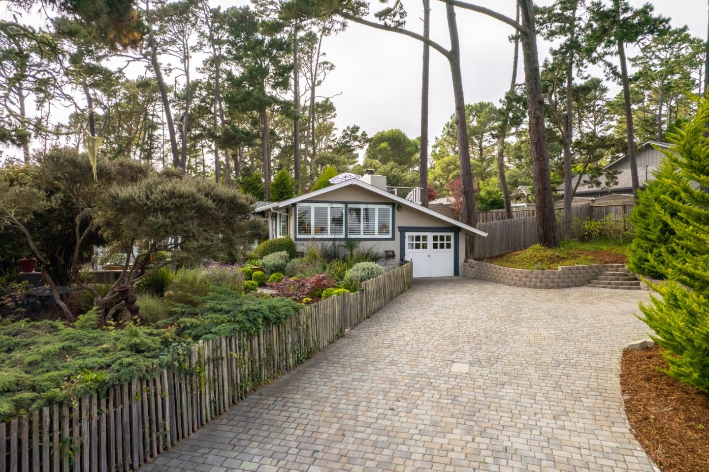 4106 Crest Road Pebble Beach, CA 93953 - Photo 39 of 43 a view of a house with a small yard and large trees
