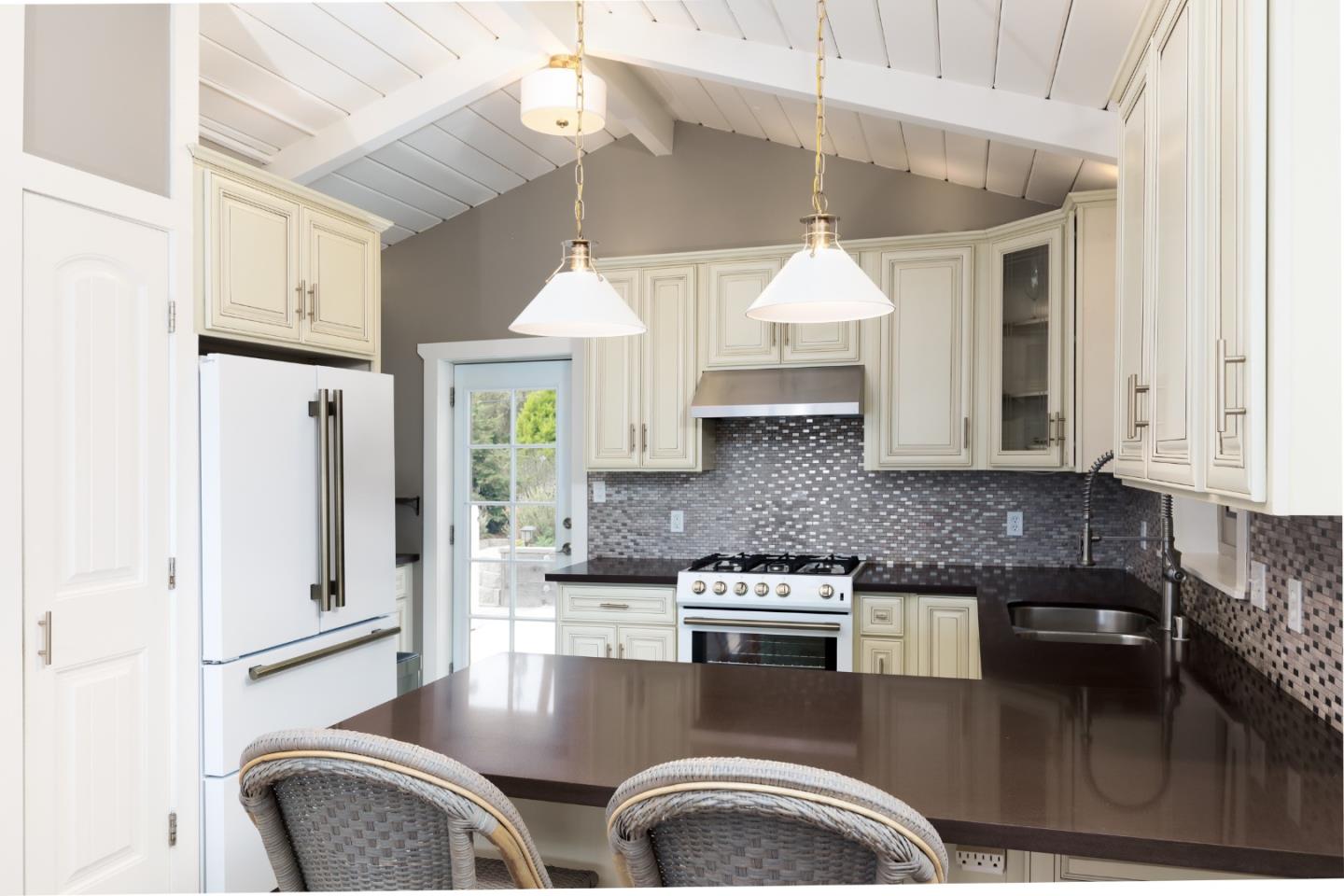4106 Crest Road Pebble Beach, CA 93953 - Photo 10 of 43 a kitchen with stainless steel appliances granite countertop a stove a refrigerator and a cabinets
