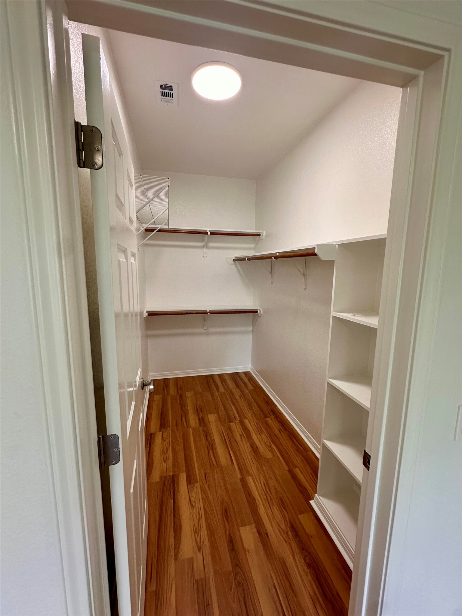 1122 Mansell Avenue Austin, TX 78721 - Photo 18 of 29 a view of walk in closet with empty racks