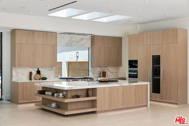 a kitchen with stainless steel appliances a stove and more cabinets