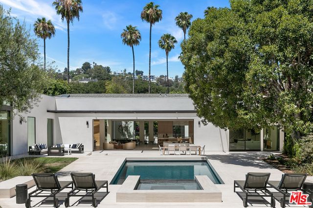 a view of house and outdoor space with swimming pool