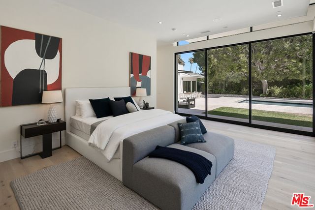 a bedroom with a large bed and a large window