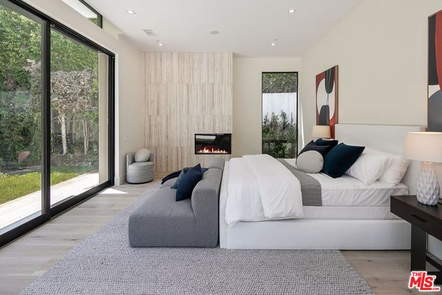 a bedroom with a bed and glass window