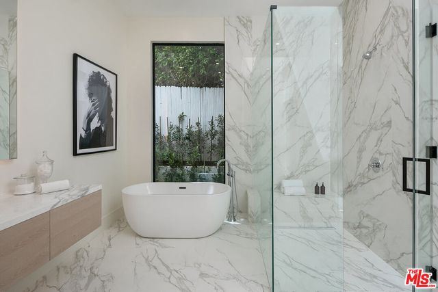 a bathroom with a bathtub and shower