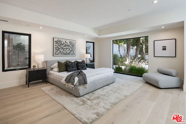 a spacious bedroom with a large bed and a couch