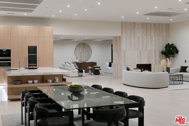 a kitchen with a table chairs stove and cabinets