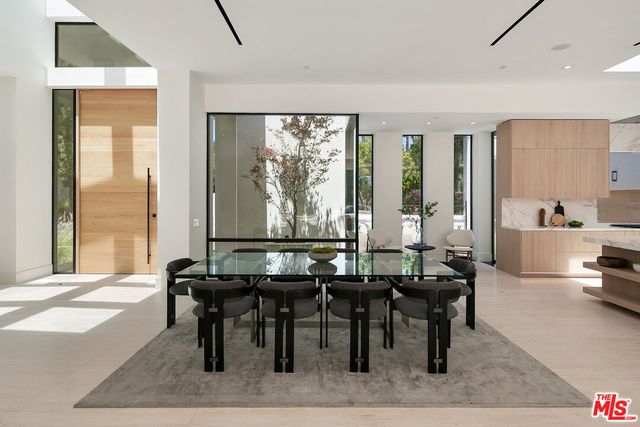 a view of a a dining room with furniture window and wooden floor