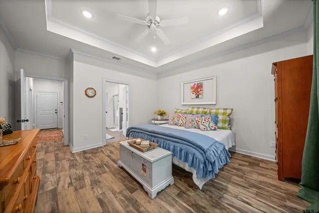 a spacious bedroom with a bed and a dresser