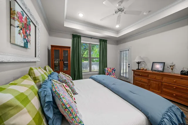 a bed room with a bed and a painting on the wall