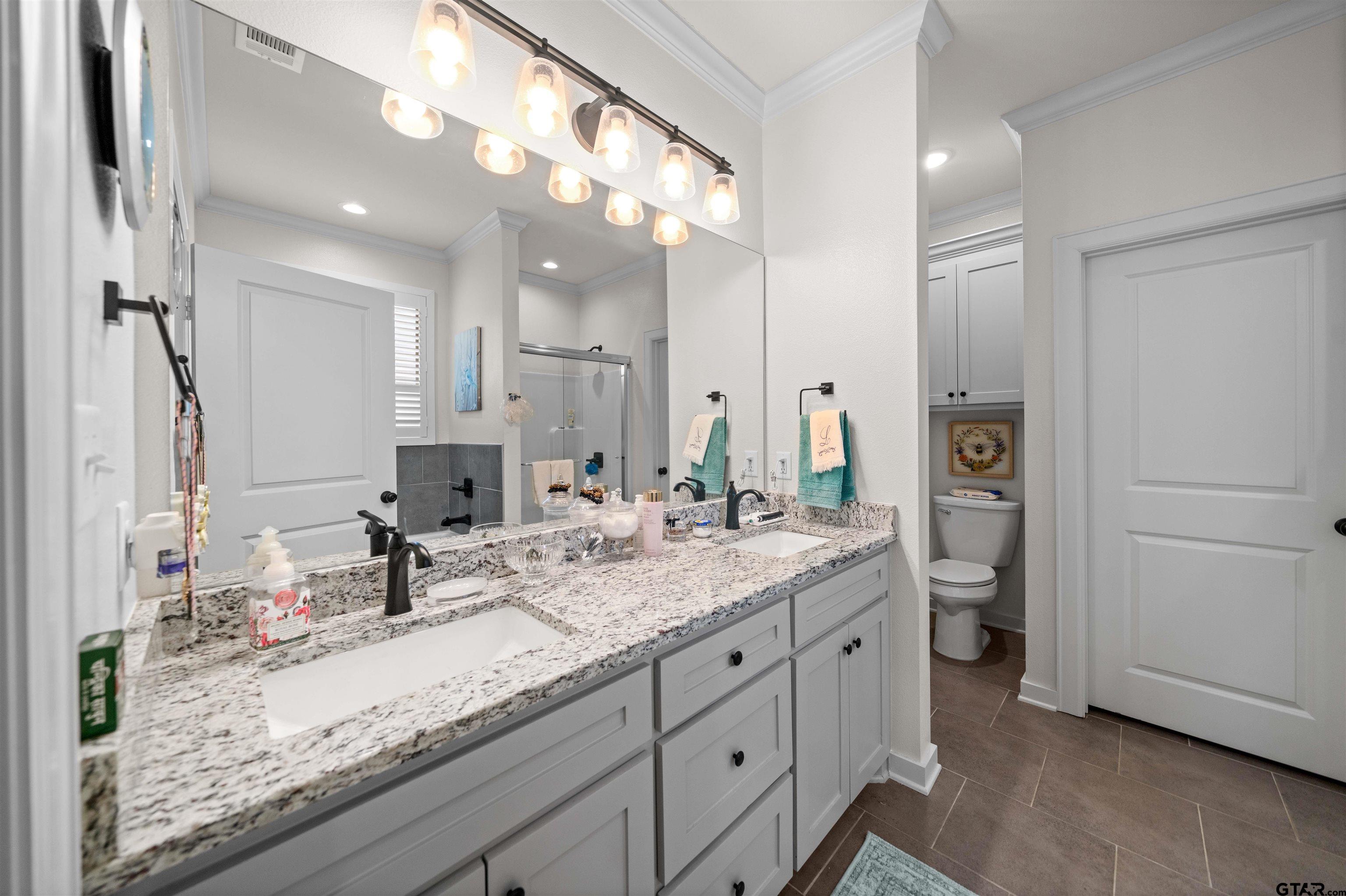 107 Rose Row Lane Winona, TX 75792 - Photo 22 of 33 a bathroom with a granite countertop sink double vanity and a mirror