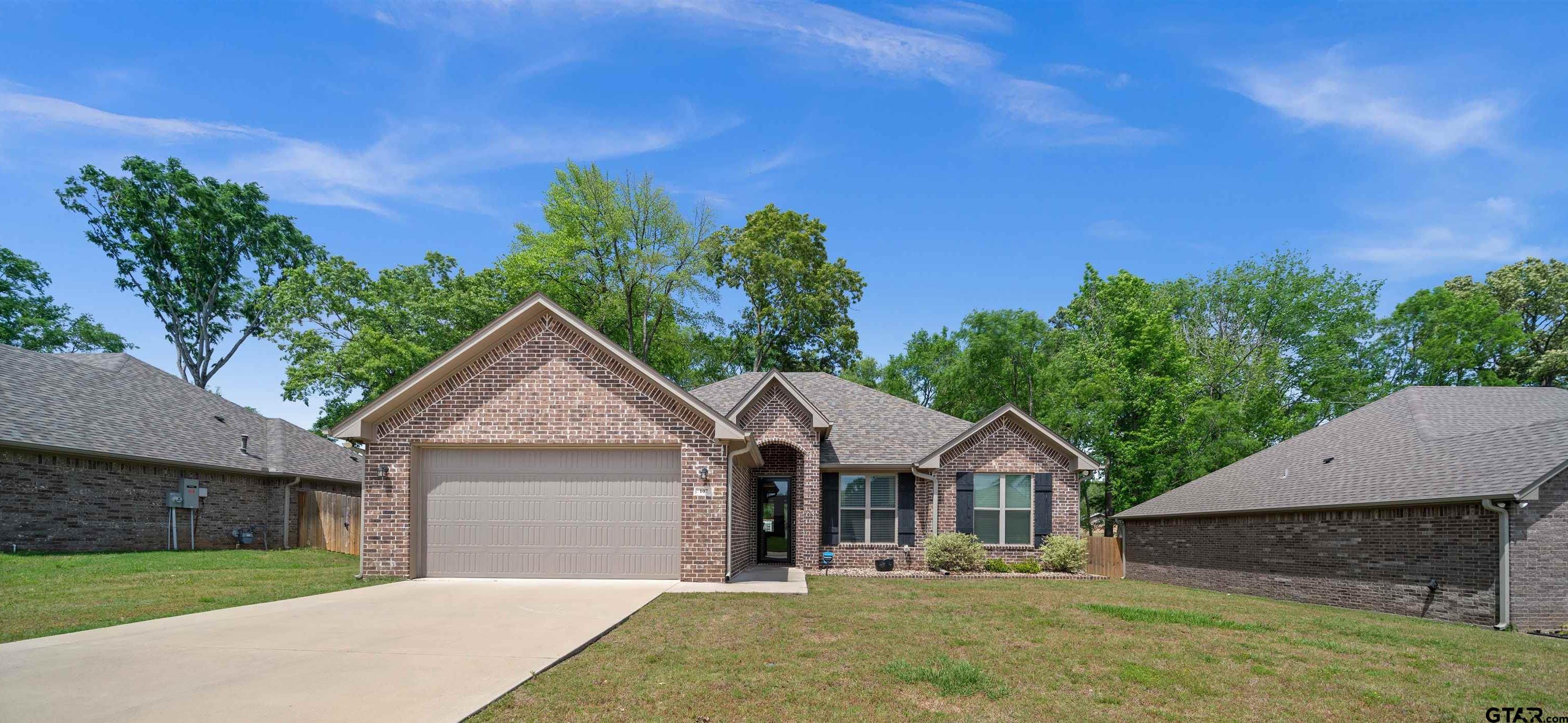 107 Rose Row Lane Winona, TX 75792 - Photo 4 of 33 a front view of a house with a garden and yard
