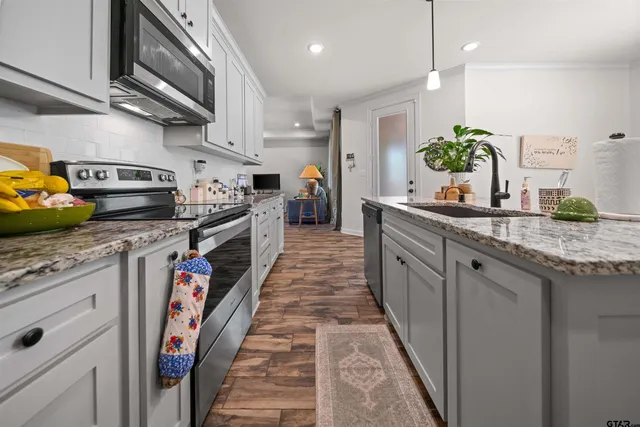 a kitchen with kitchen island granite countertop lots of counter top space