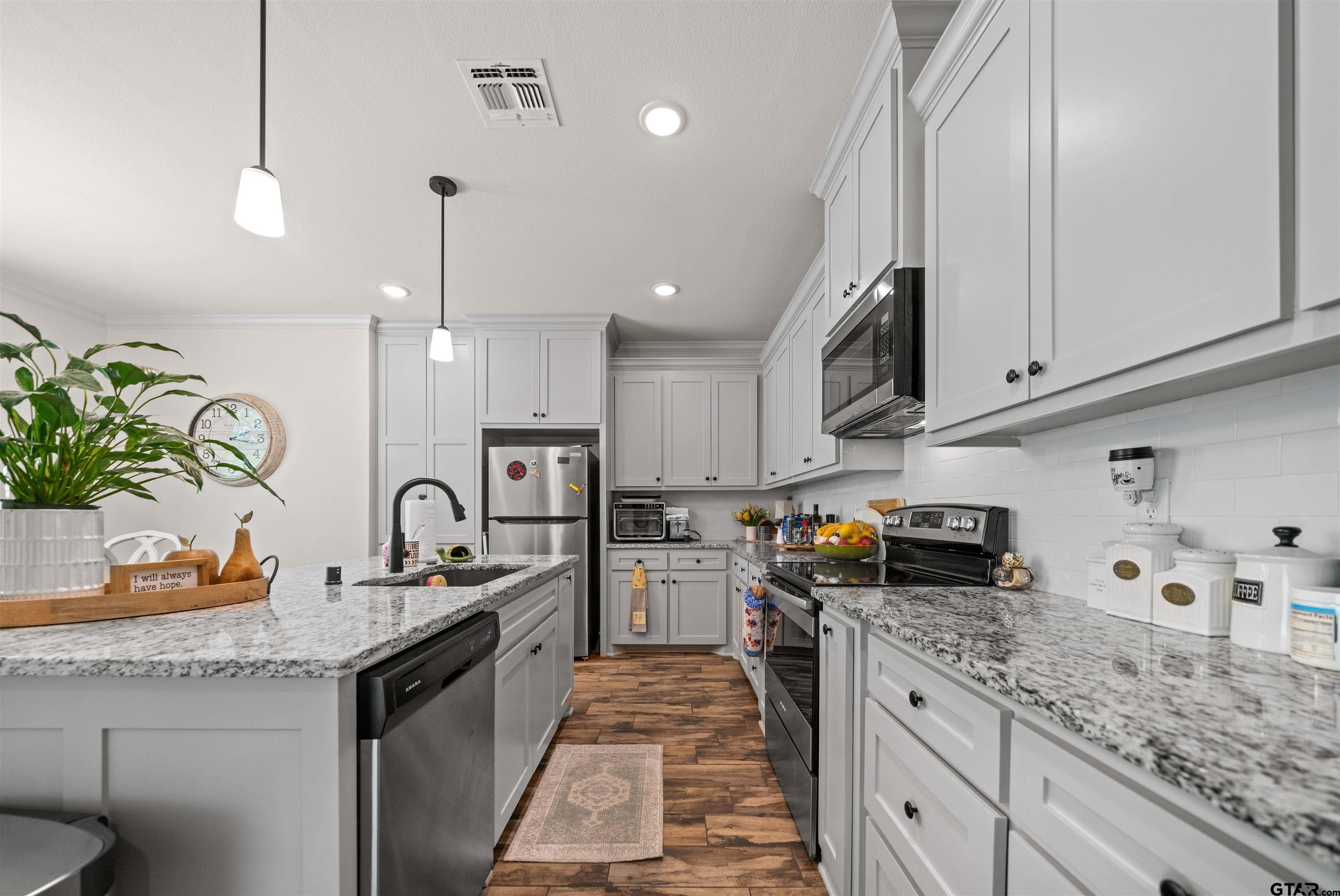 107 Rose Row Lane Winona, TX 75792 - Photo 9 of 33 a kitchen with granite countertop a sink stove and cabinets