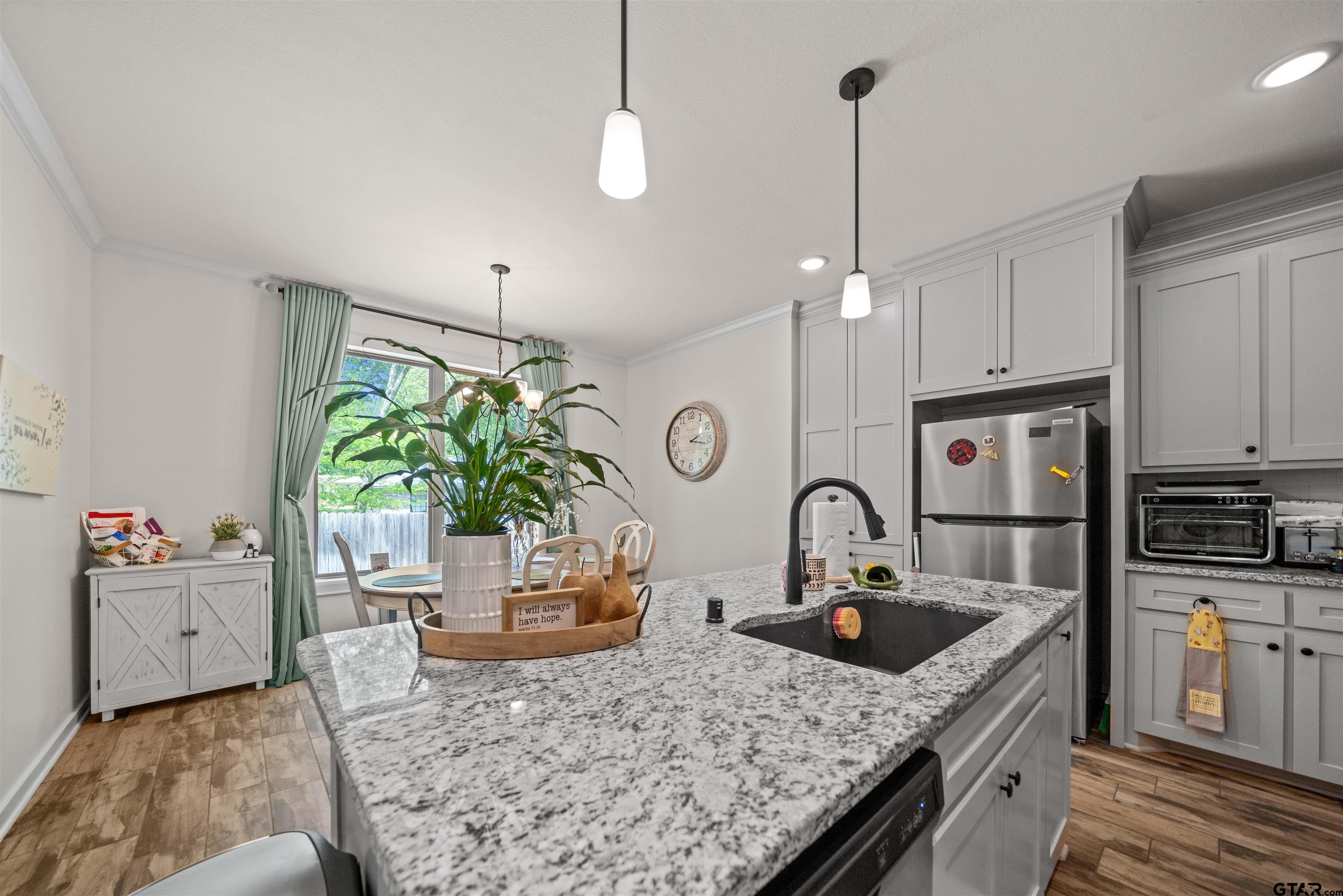 107 Rose Row Lane Winona, TX 75792 - Photo 10 of 33 a kitchen with granite countertop a sink a counter space appliances and cabinets