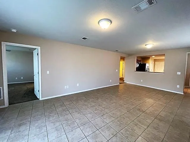 an empty room with entrance and windows