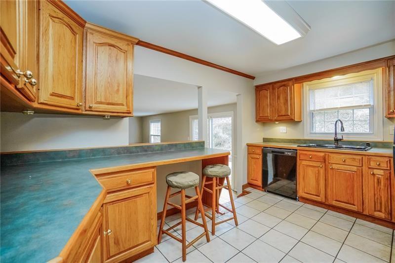 164 Friar Lane McMurray, PA 15317 - Photo 12 of 46 a kitchen with stainless steel appliances granite countertop a sink and cabinets