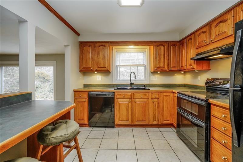 164 Friar Lane McMurray, PA 15317 - Photo 15 of 46 a kitchen with stainless steel appliances granite countertop a stove a sink and a microwave